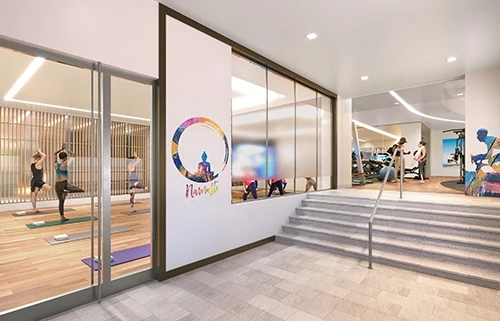 Yoga studio with stairs leading to indoor fitness area